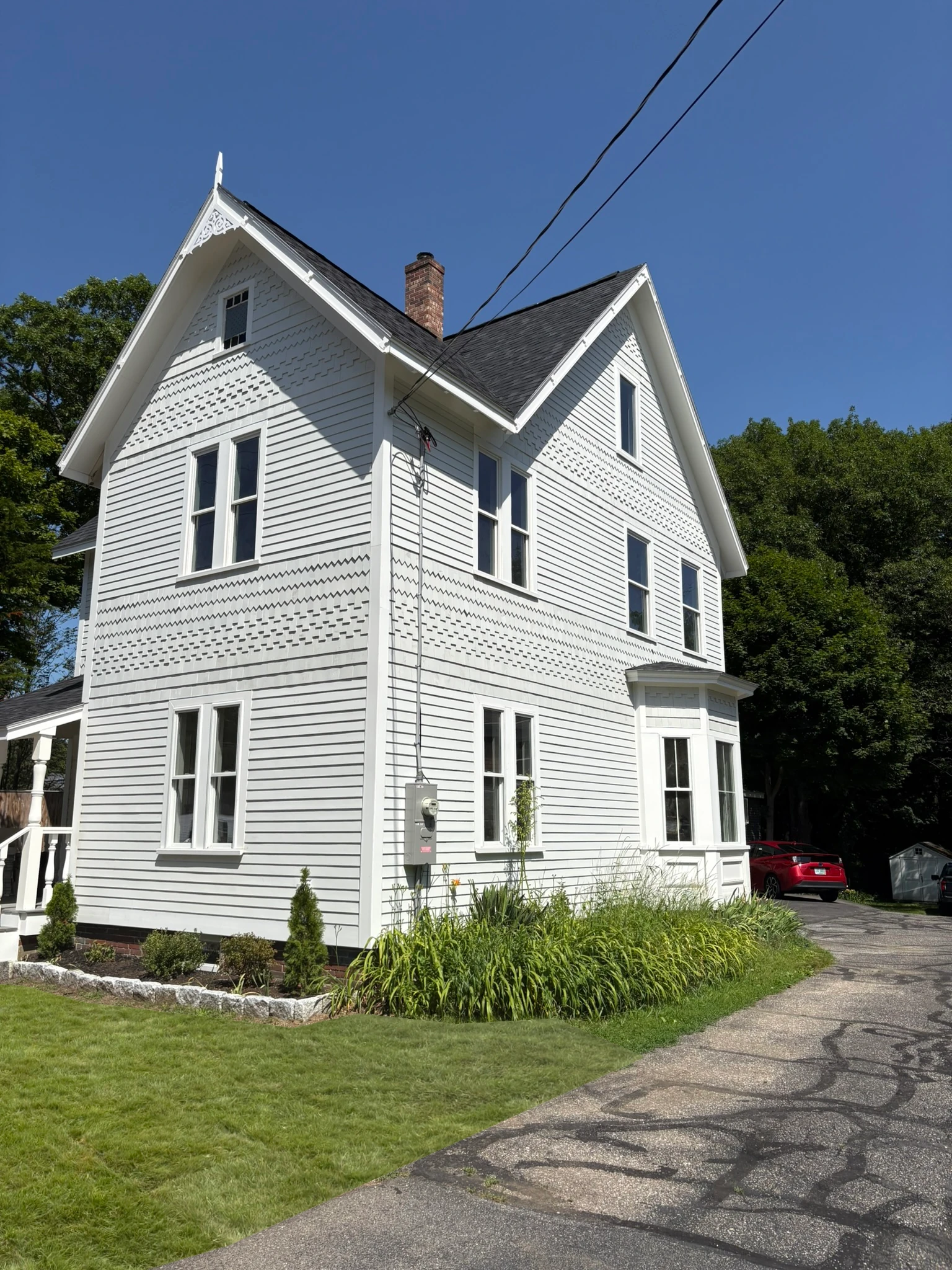 The restored elevation with new siding and bay