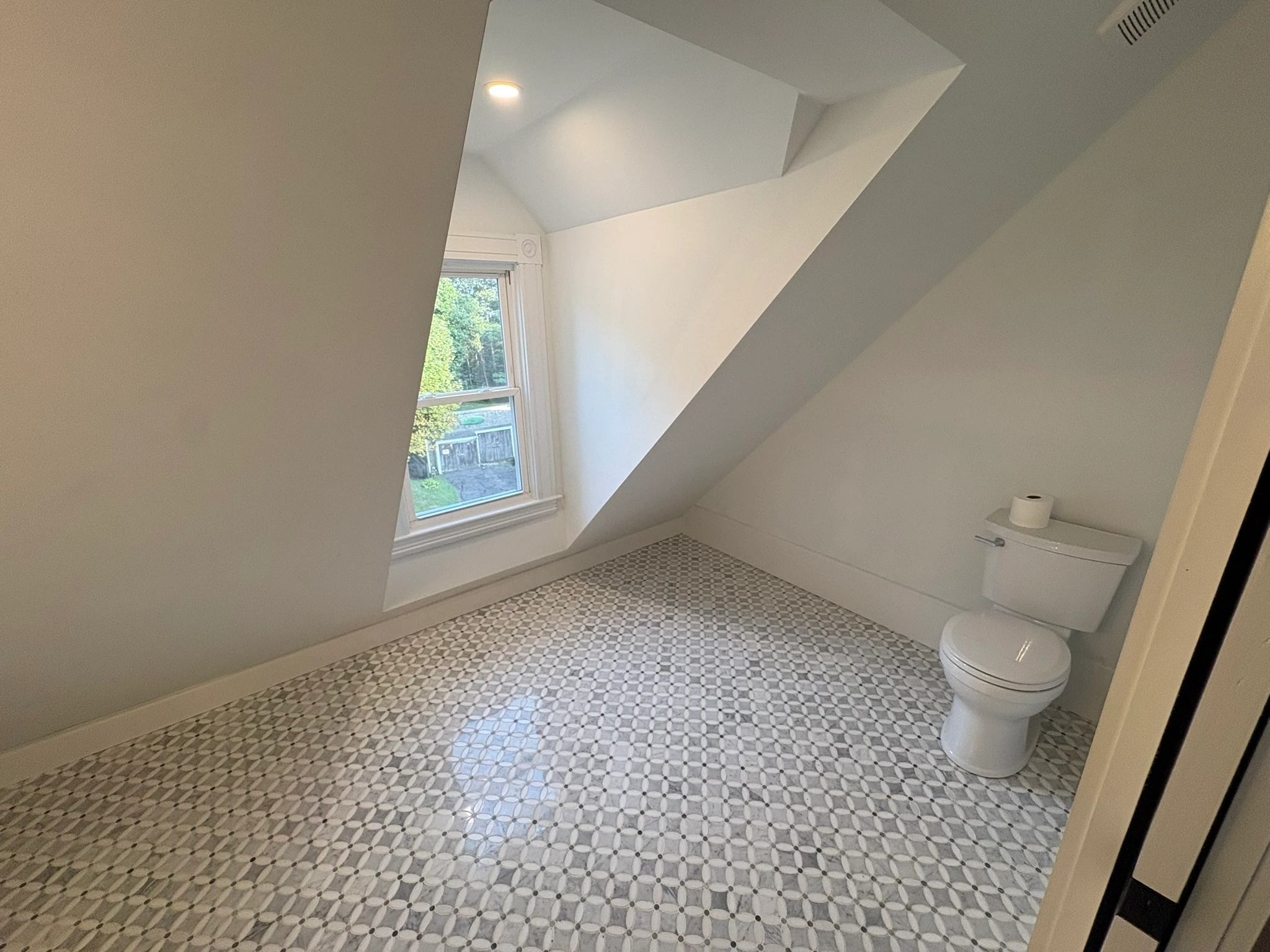 Attic bathroom under the angled ceiling