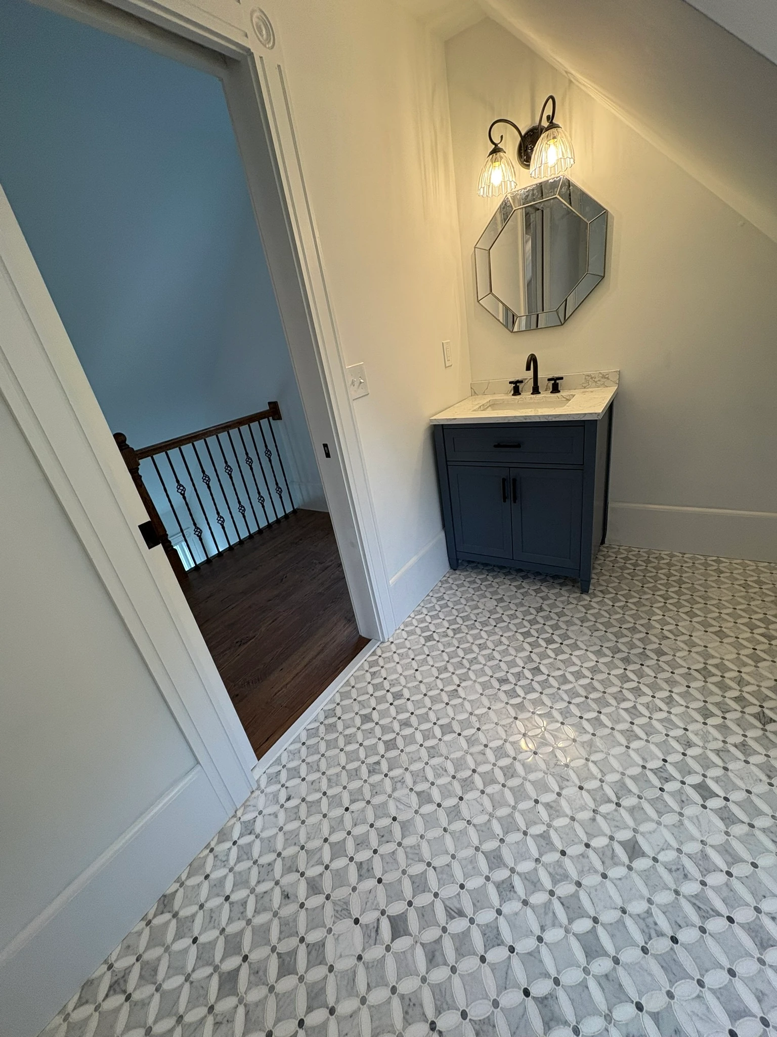 Attic bath vanity beside the doorway to the landing