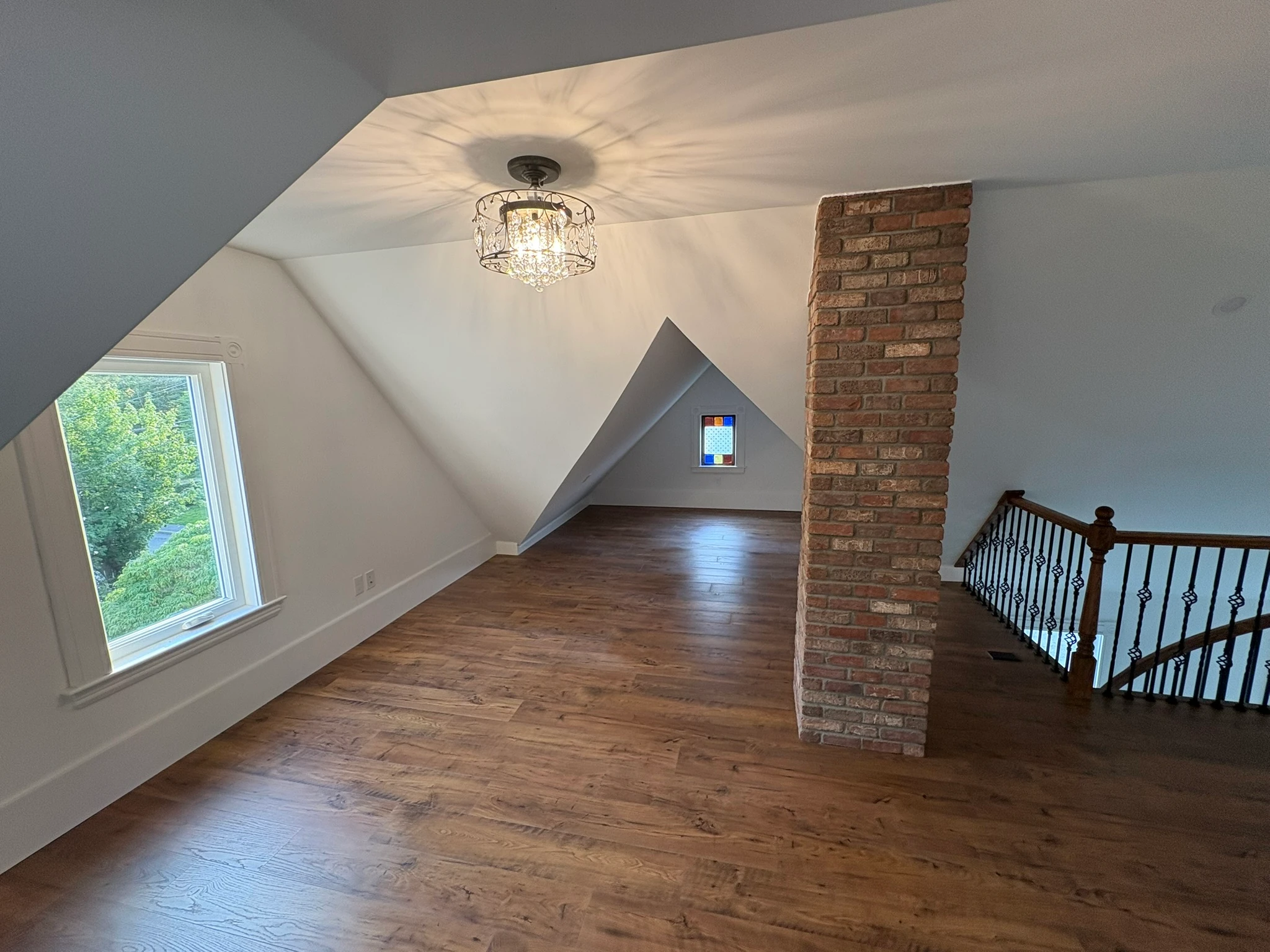 The same attic, restored — chimney and stained glass preserved