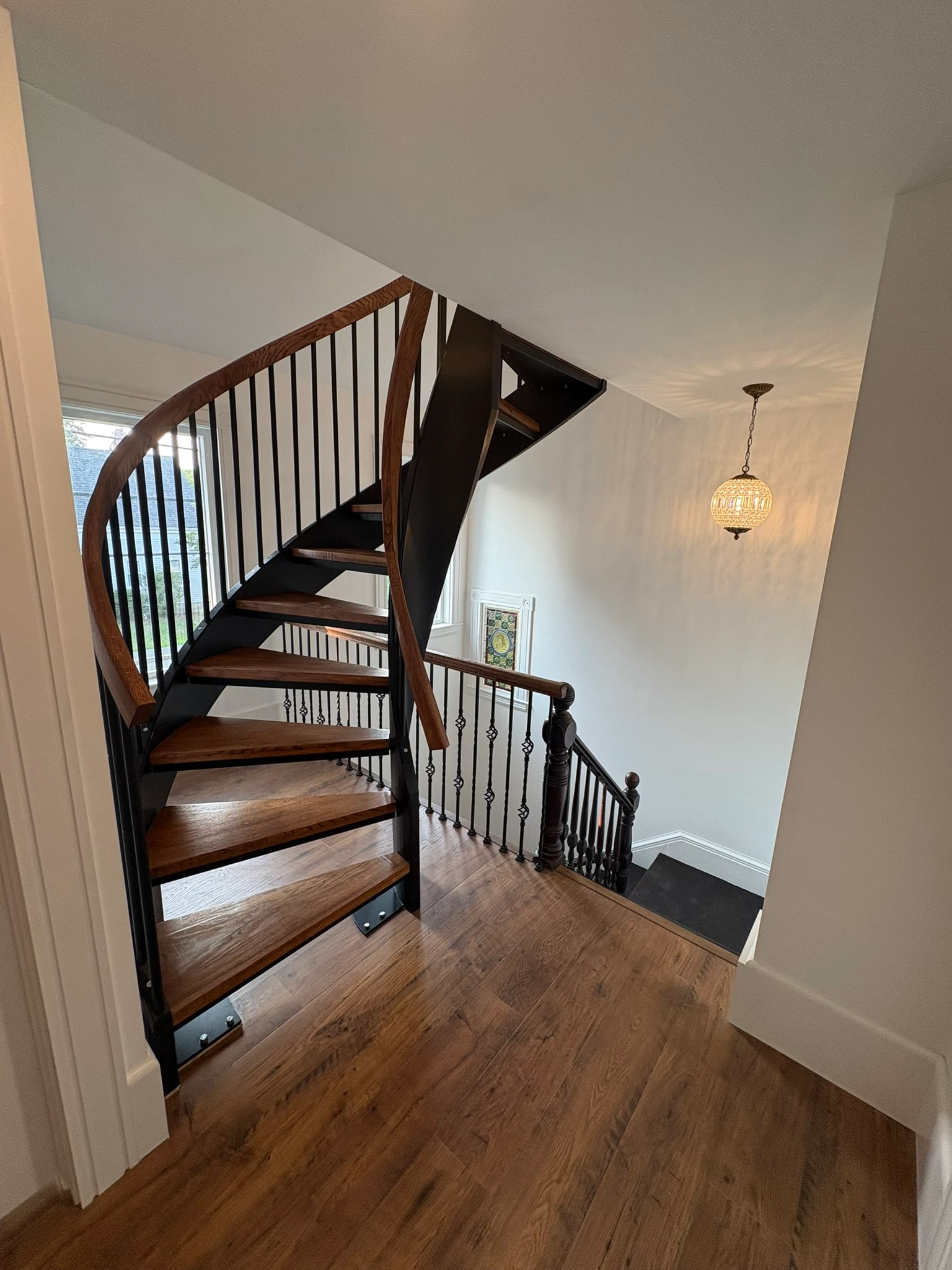 Descending the curved staircase