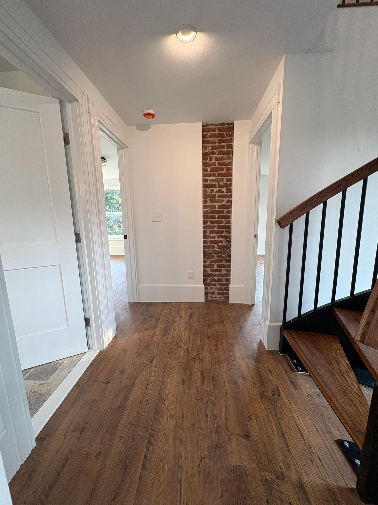 Restored second-floor hallway with exposed brick
