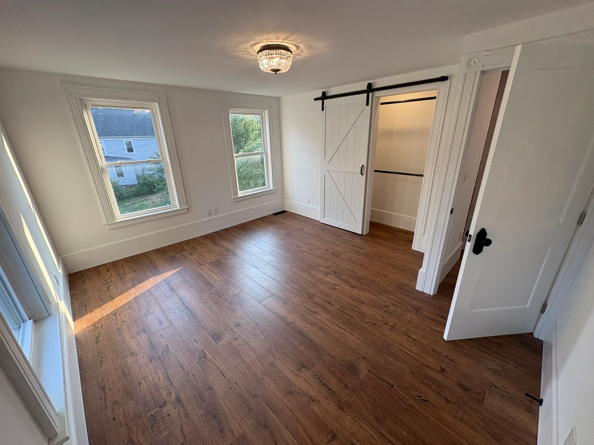 The restored bedroom with barn-style closet door