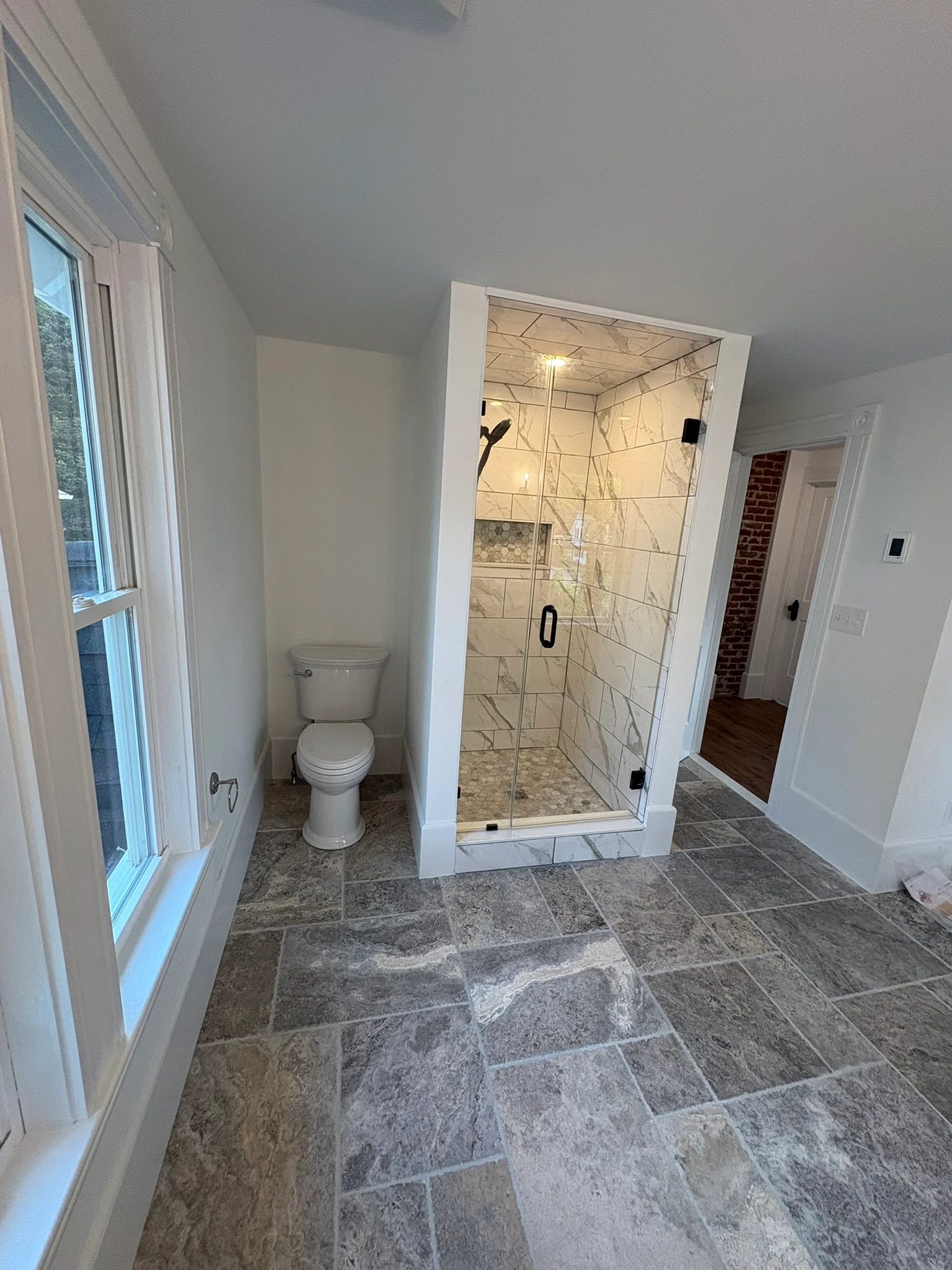 Glass shower and stone floor