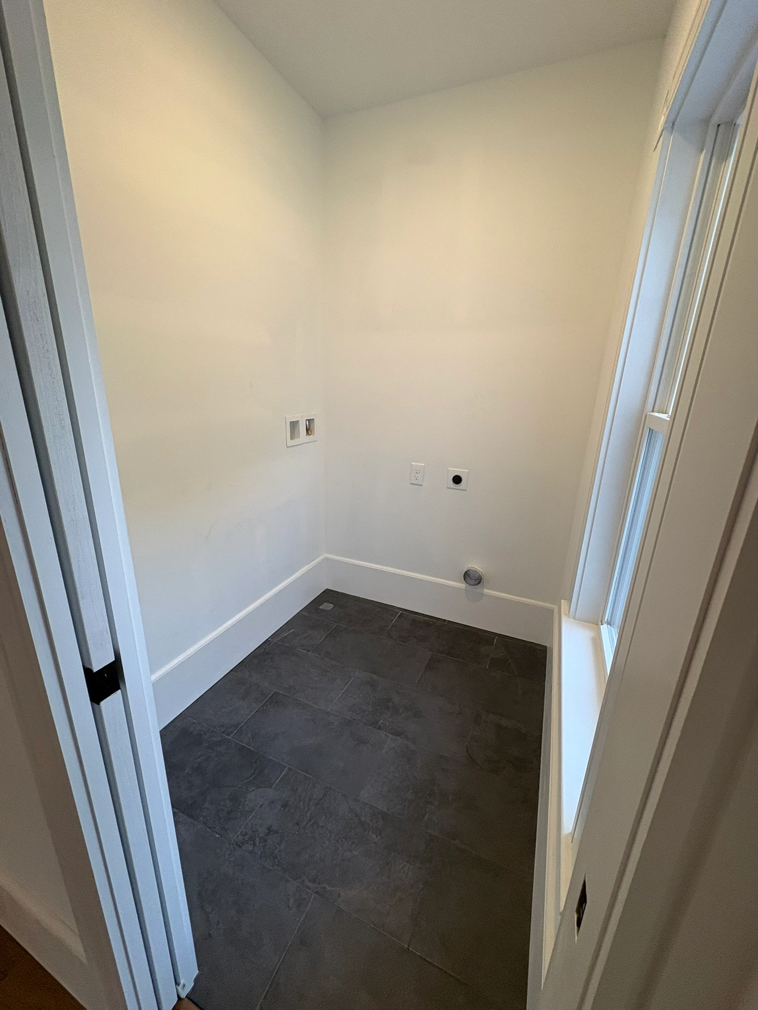Laundry room with slate floor and washer hookups