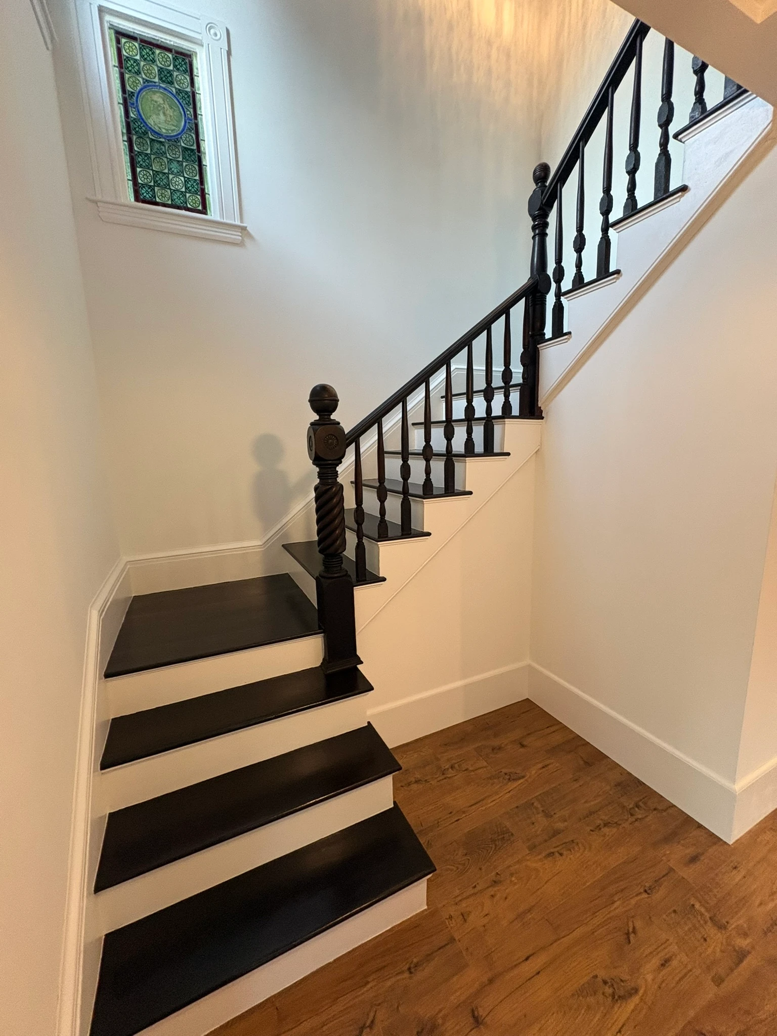 The original staircase restored, stained glass above