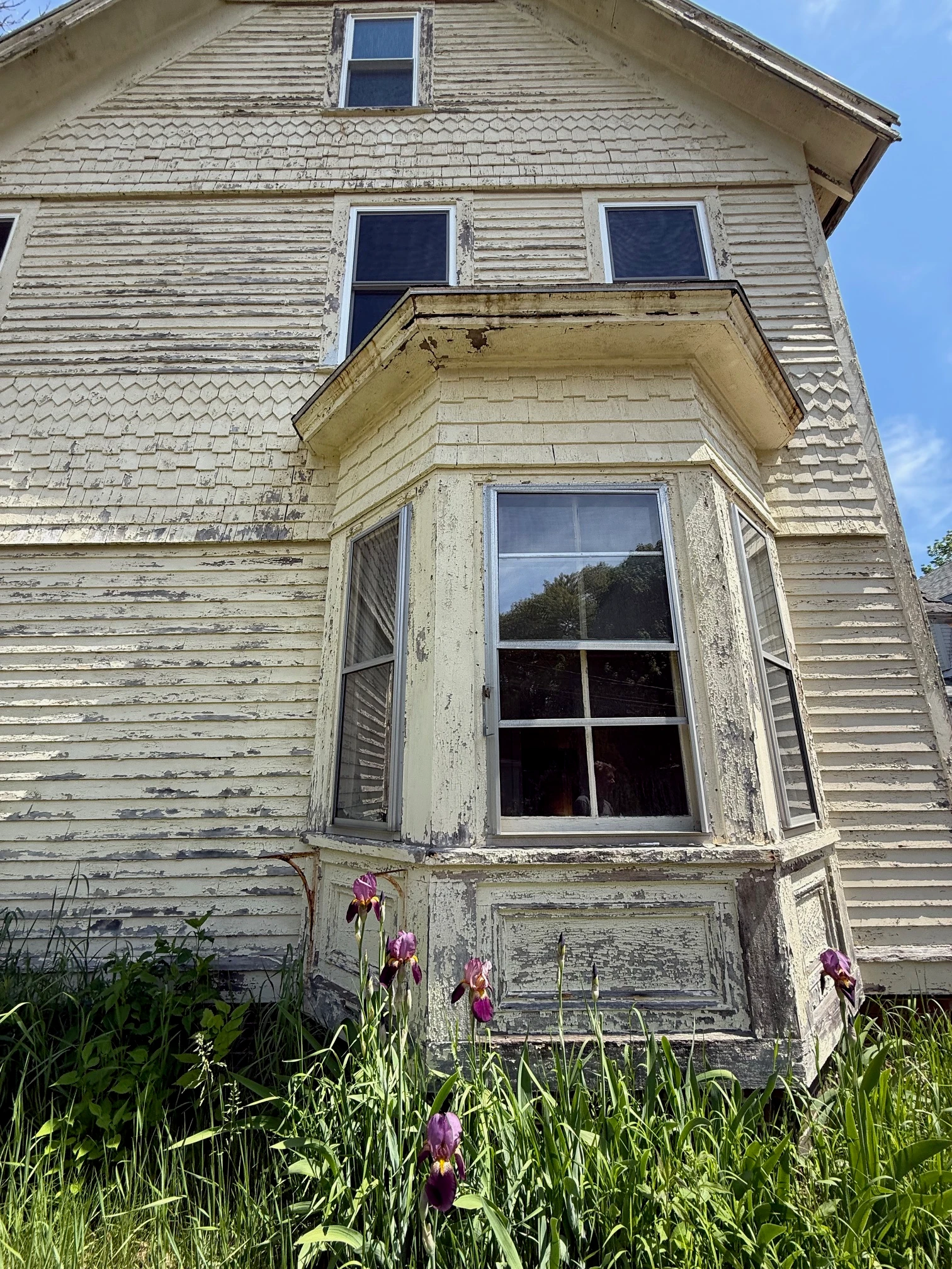 Bay window with weathered siding