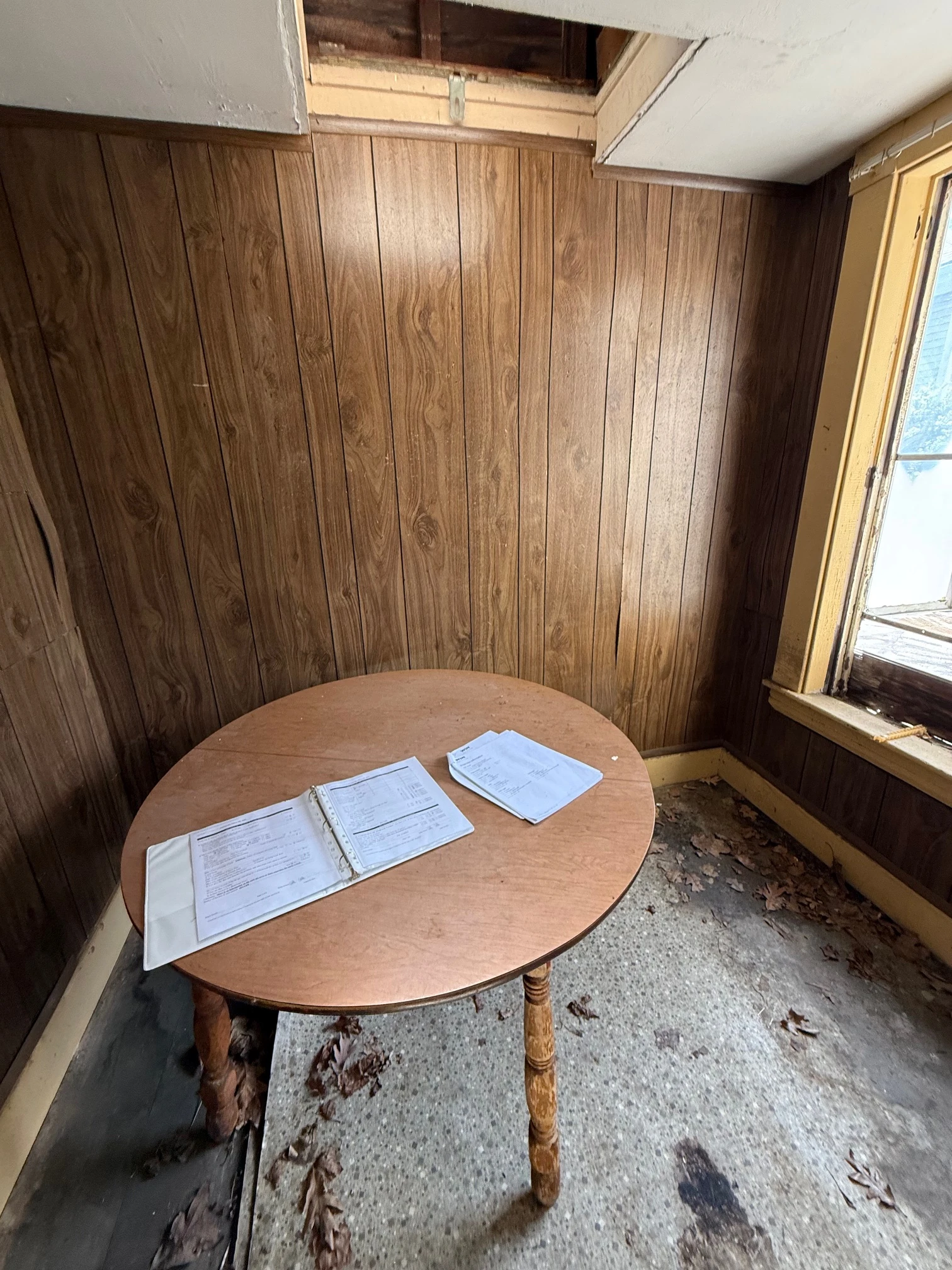 Wood-paneled sitting room with a round table