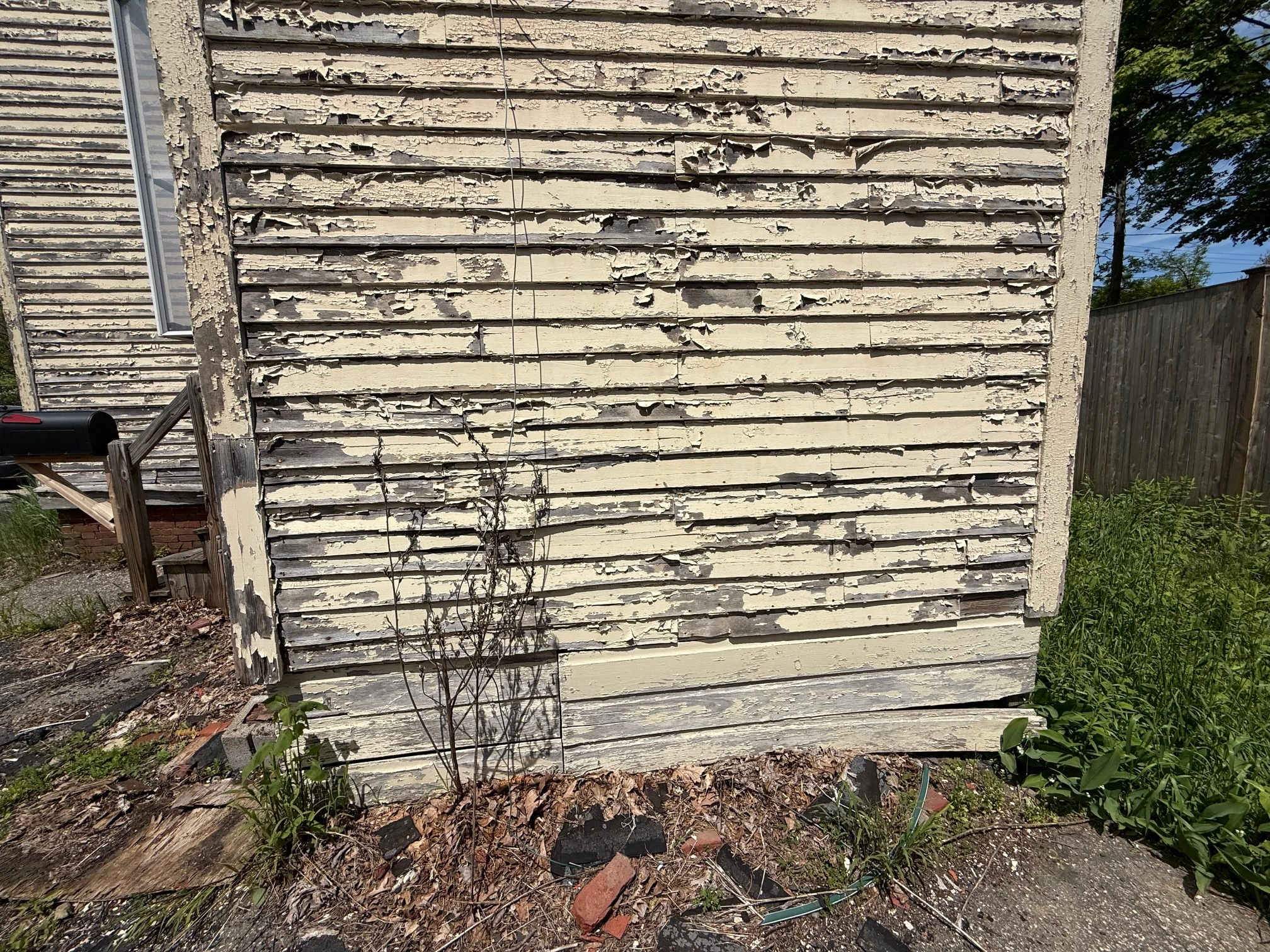 Peeling paint on the original clapboard